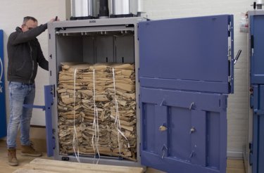 man-in-black-shirt-bales-out-a-cardboard-bale-safely